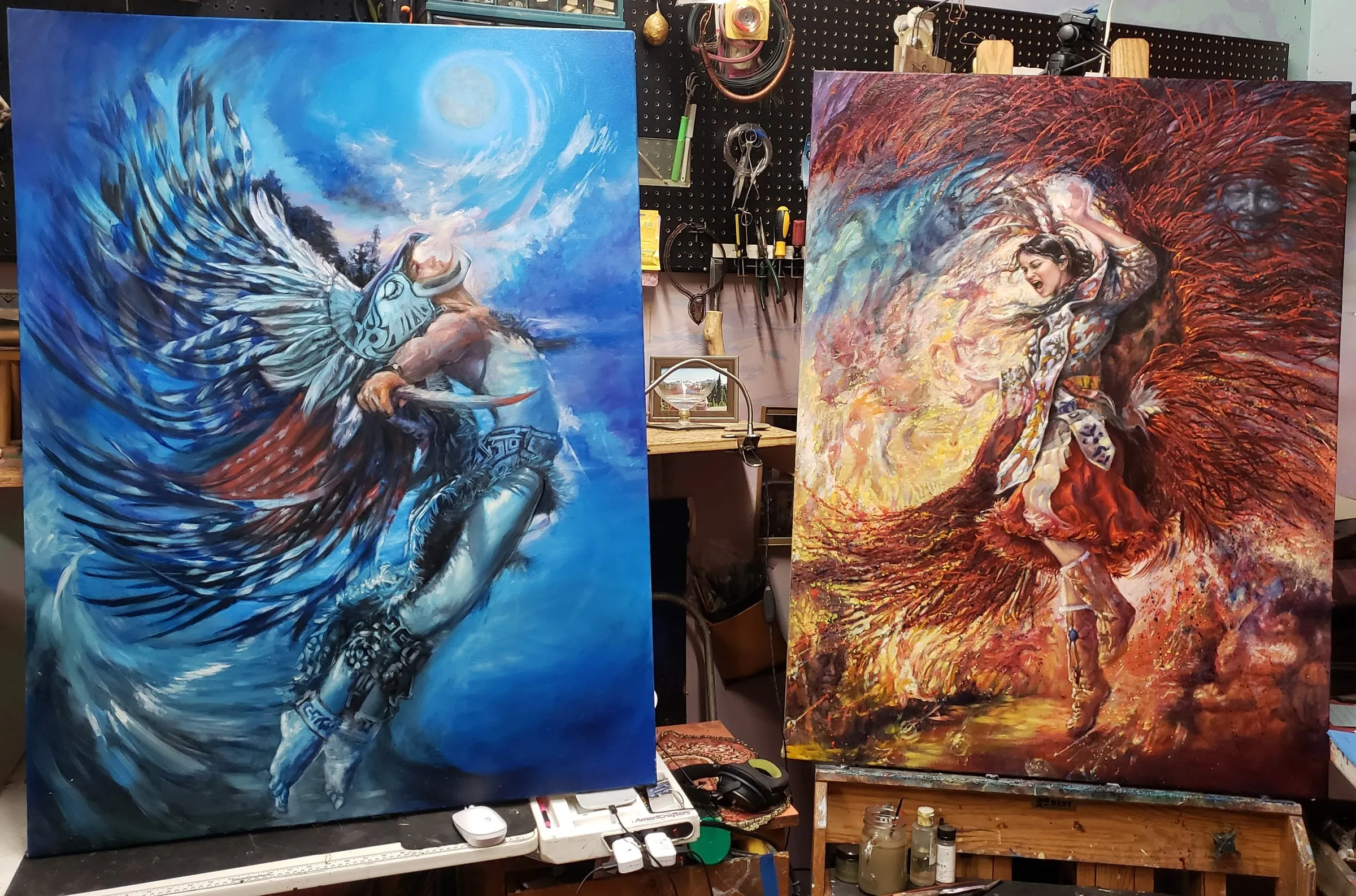 Blue Kachina and Red Kachina, oil paintings by Colleen Black, standing on easels in a studio